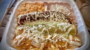 Three different enchiladas topped with three different sauces mole , Verde , Rojo  at Hugo's Cocina  in San Diego