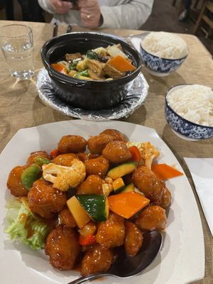 Sweet and sour pork and white rice. In the back, tofu clay pot and coconut rice.  at Vegie Bowl in Springvale