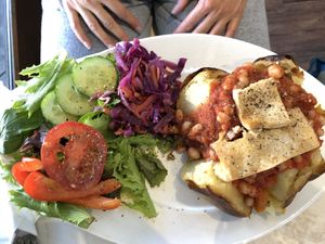 Baked potato topped with homemade beans, maple tofu & roast veg at Coco's Canteen  in Weston-super-mare