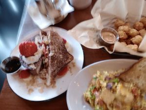 Sorry for the blurry photo; the french toast, country breakfast and tater tots were clear in person. at The Wild Chive in Long Beach