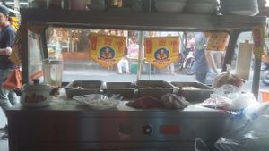 "Kin jay" ("Vegan" in Thai) flags as seen from the table at Pan Road - Vegan Food Cart in Bangkok