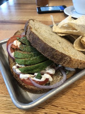 The avocado basil sandwich with onion and vegan sour cream drizzle on sourdough  at Living Kitchen in Chapel Hill