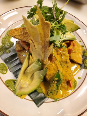 Vegan mofongo called Machuca, made with mashed green & sweet plantains topped with eggplant & avocado with coconut saffron sauce at Casa Yari in Chicago