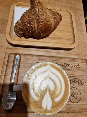 Oatmilk cappuccino and citrus croissant (vegan) at Madal Coffee Co - Ferenciek Tere in Budapest