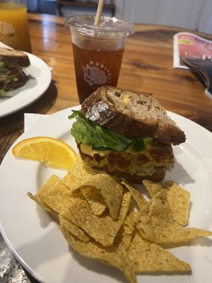 Sweet tea and Vegan Breakfast sandwich on sourdough bread w/ tortillia chips.  at Huriyali in Charleston