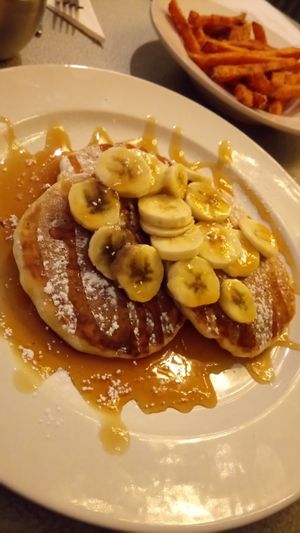 Vegan pancakes with maple syrup and banana. at The Fat Cyclist Cafe in Stirling