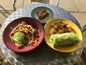 Chilaquiles, breakfast burrito & 2 sides of tempeh bacon  at The Grain Cafe in Long Beach