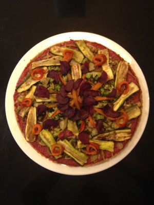 Triangle : vegan glutenfree homemade dough with beetroot pesto, sautéed leeks and fennel and roasted pumpkin and brocoli at Dosa Nova in Sitges