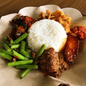 Rice plate with vegan beef rendang, green beans, eggplant, fried mushrooms  at Alpukat Bistro in Jakarta