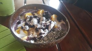 Smoothie bowl, and the green goblin smoothie in the background at Fruto Juice Bar in Kota Kinabalu