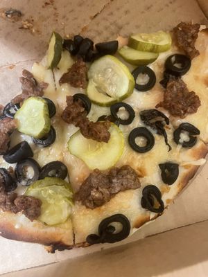 Gluten free vegan pizza- violife cheese, pickles, black olives and beyond burger  at Pizza Palace in Milford