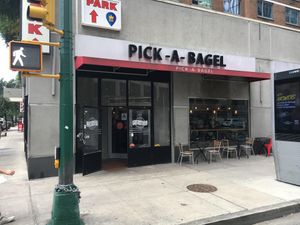 Front of store, with some outdoor seating. at Pick A Bagel in New York City