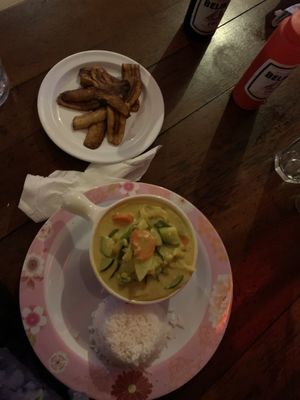 Coconut curry with a side of plantains  at Fantasy Dining in Caye Caulker