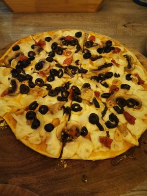 Make your own pizza. Vegan cheese, Olives, garlic, Sundried tomato and mushroom. at La Matatena Pizzeria in Oaxaca
