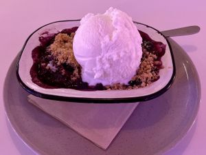 Apple and blueberry crumble with coconut ice cream. (That was the ambient lighting at the table, not a photo filter.) at Veg Bar in North Hobart