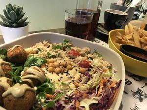 Falafel bowl, fries, and passion fruit iced tea  at Marta's Veggie Fusion in Split