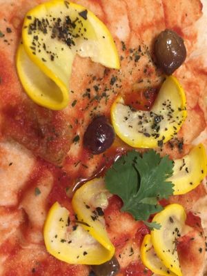 Pinsa vegan with biologic tomatoes sauce,zucchini,olives,parsley at Pinsa & Co in The Hague