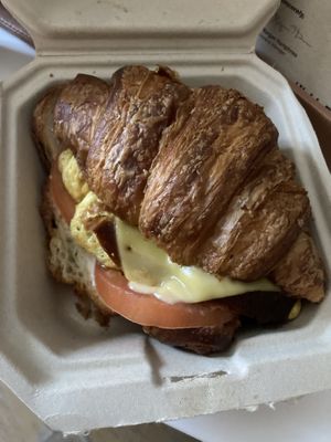 Breakfast croissant sandwich with added tomato and avocado  at Orchard Grocer in New York City
