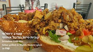 Jerusalem Grill Mix: Seitan grilled in Middle Eastern spices, served in a bun with veggies and house condiments at Veggies Bar in Jerusalem