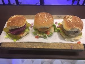  Three mini-burgers; mushroom, beet and sweet potato, topped with veggies and house condiments at Veggies Bar in Jerusalem