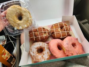2 apple fritters, 1 glazed, 2 strawberry sprinkled, and one caramel at Five Daughters Bakery - Eastland Ave in Nashville