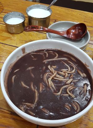 Vegan red bean (adzuki bean) soup with hand-cut noodles 팥칼국수 seasoned with salt and sugar according to personal preference at Baengnyeonok - 백년옥 in Seoul