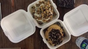 Top is marshmallow topping and cookie dough, bottom is peanut butter and oreos. Brownie in top right corner. at Cinnaholic in San Diego