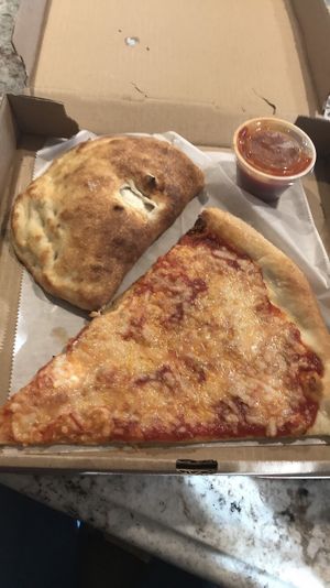 Vegan cheese calzone and slice at Pazzo Wood Fired Pizza in Wading River