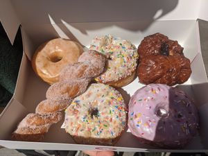 All the vegan flavors for the week. Usually half are vegan and half are only vegetarian.  at Doughnut Party in Edmonton