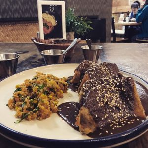 Molanesa 
Wheat milanesa in mole with quinoa side
The potatoes are under the milanesa  at Inspiracion 9 in Tijuana