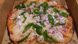 Vegan personal pizza with gluten-free crust, dairy free cheese, green peppers, and red onions. at BRK Pizza in Naples