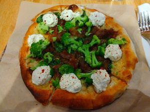 "Spinach and Mushroom Pizza" but I got broccoli instead of mushrooms. It also has lemon almond ricotta, caramelized onions and spinach. at True Food Kitchen in Naples