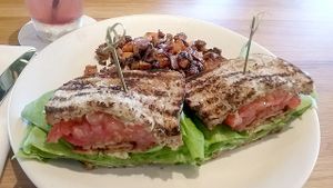 T.L.T. Sandwich featuring smoked tempeh, lettuce, tomato, vegan mayonnaise, and avocado, plus a side of sweet potato hash. at True Food Kitchen in Naples
