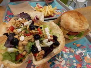 Greek salad, french fries in the back, burger 🤤 at Khambú Quart in Valencia