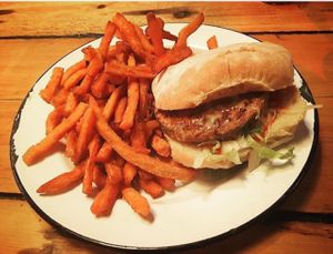 Vegan burger with seitan patty, vegan cheese and bun. Sweet potato fries.  at Box Burger in Bray