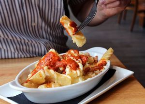 Crispy yucca frites topped with a housemade aioli, smoked paprika and chile de arbol hot sauce at Malo in Des Moines