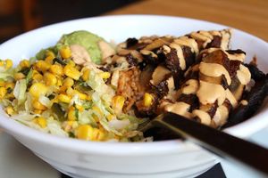 Burrito Bowl with marinated and grilled portobello mushroom, vegan chipotle crema, black beans, rice, corn salsa, guacamole and salsa roja at Malo in Des Moines