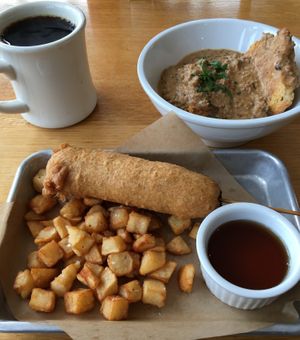 Super satisfying Sunday brunch: Maple Sausage Corn Dog with Breakfast Potatoes. Biscuits & Gravy. at J Selby's in St Paul