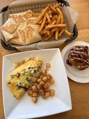 Breakfast Crunchwrap comes with fries (top), mushroom Swiss omelette comes with potatoes (bottom), caramel pecan sticky bun (right)   at J Selby's in St Paul