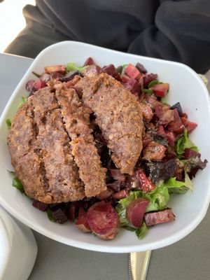 Roasted veggie salad topped with a Beyond Burger at MidMod Cafe in Palm Springs