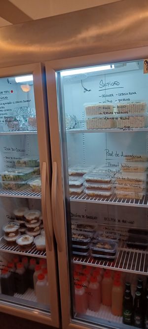 Cold food options. Descriptions on the fridge. Dessert on the bottom shelf. at Vegano SP in Sao Paulo