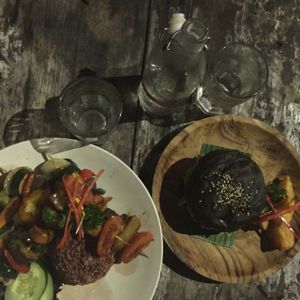 Vegetable skewer wit red rice & vegan burger on a black bun  at Nook in Kerobokan Kelod