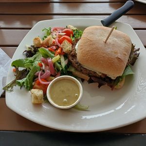 Black Bean Burger w/ avocado, tomato, spring mix & house vegan ranch on ciabatta bun (+$3) side salad w/ carrot, tomato, pickled red onion, cucumber, croutons & Italian vinaigrette at Benson Brewery in Omaha