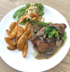 New menu: Grilled Chicken Chop top with freshly made mushroom sauce. Serve with fresh salad and potato wedges! Everyone should try.  at Harmony Hut International Food in Northeast Singapore