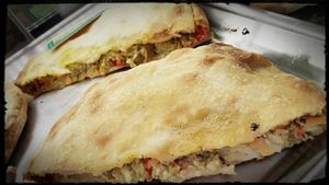 Vegan pie with broccoli, red sweet peppers, groats, herbs and spices at Starenio Bakery in Corfu