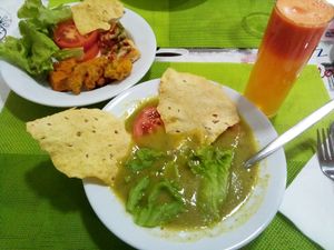Carrot, lemon and ginger juice; broccoli soup; salad, wheat cake, fried snacks, mini vegan pizzas. at Lisbon Vegan Restaurante in Lisbon
