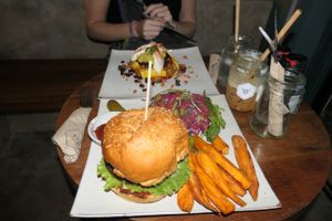 Honest burger with sweet potato fries   at Vibe Cafe in Phnom Penh