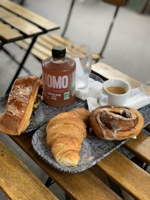 Self-created Breakfast meal. Swiss brioche with crème pâtissière, the original croissant and cinnamon roll. Accompanied with peach hibiscus iced tea and espresso.  at VG Pâtisserie in Paris
