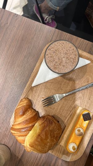 croissant, pain au chocolat, hot chocolate and a dessertt  at VG Pâtisserie in Paris