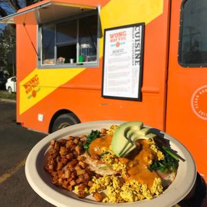 Veggie Benedict topped with avocado cashew hollandaise, fresh tomato slices, sautéed spinach, avocado and your choice of organic eggs or tofu scramble at WongWayVeg - Food Truck in Denver